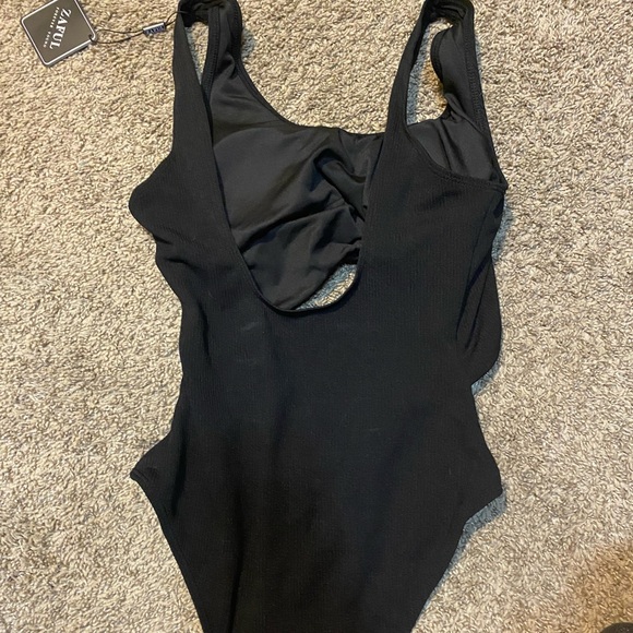 Black one piece with open front. - Picture 2 of 2